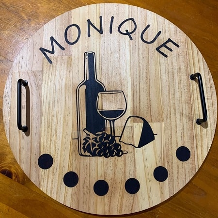Finished wood burning project showing the wine and grapes design and the black handles which set the design off nicely.