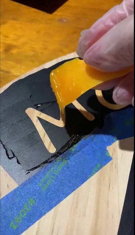 Using a squeegee apply the torch paste in all directions
