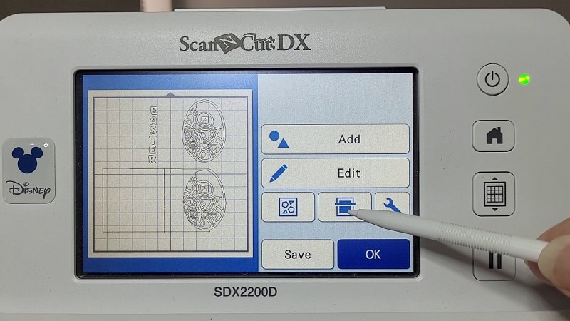 Scanning icon on the SDX2200D Brother ScanNCut cutting machine. This scans the various materials on your mat for precision placement of the design.