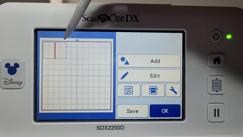 Showing the LCD screen of the Brother SDX2200D with a card and fold line highlighted.